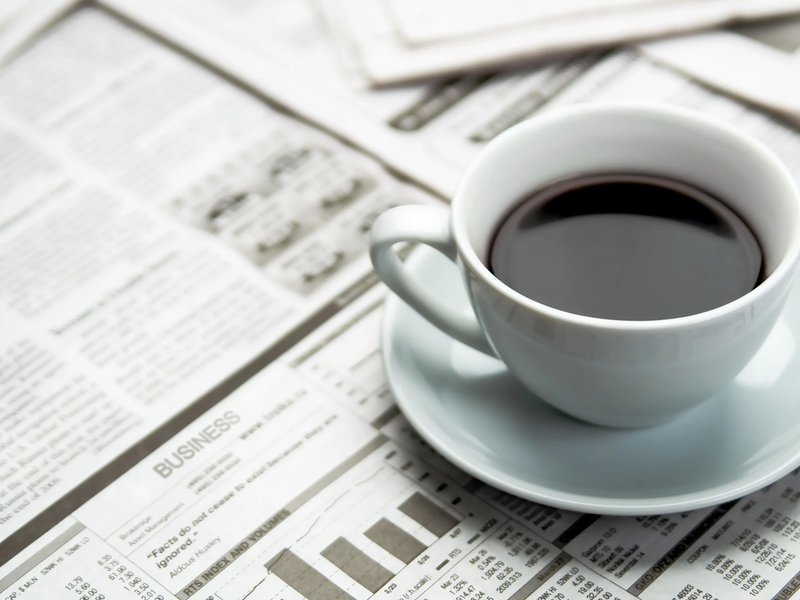 A cup of coffee on the newspaper